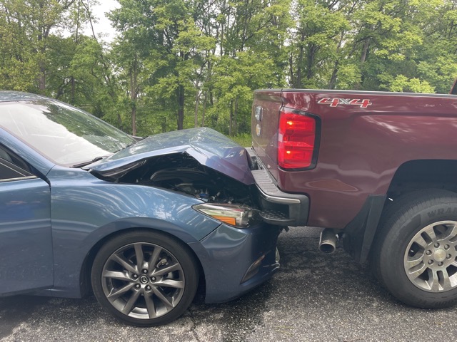 Moments after the crash.  My car was still firmly hooked on the bumper of that truck.