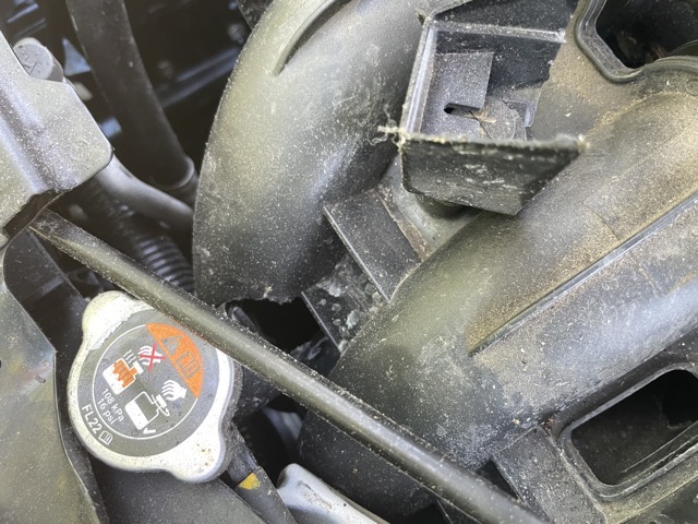 Closer inspection revealed that the plastic intake manifold was partially shattered.  There's no way this would have been cheap to fix.