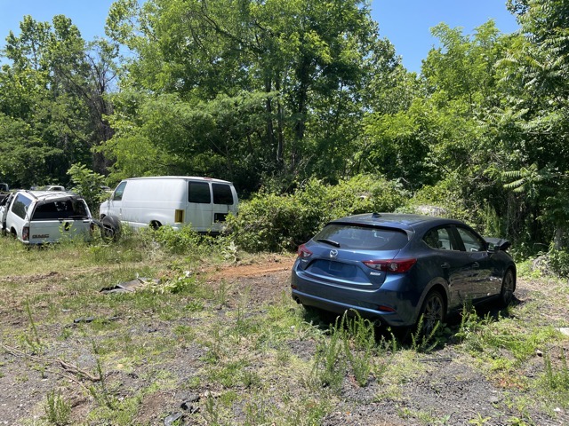 My beautiful blue car, dumped on a back junk lot, waiting to be taken away.