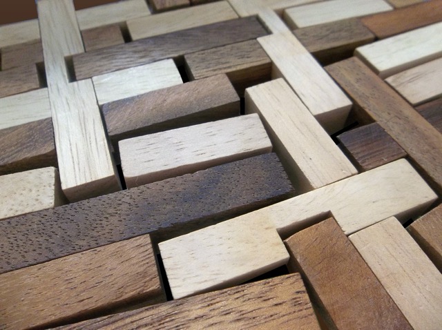 A wooden puzzle meant to form an octahedron, but with all its interlocking pieces disassembled and laid out flat. (2014)