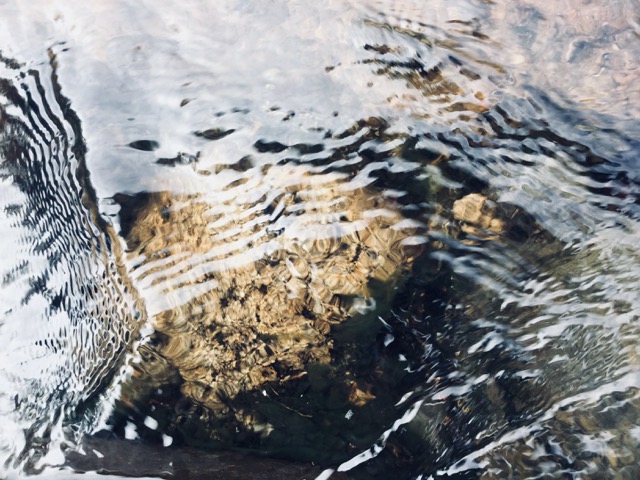 The flow of a stream disturbed by a shallow rock in the White Mountains, NH. (2017, color graded)