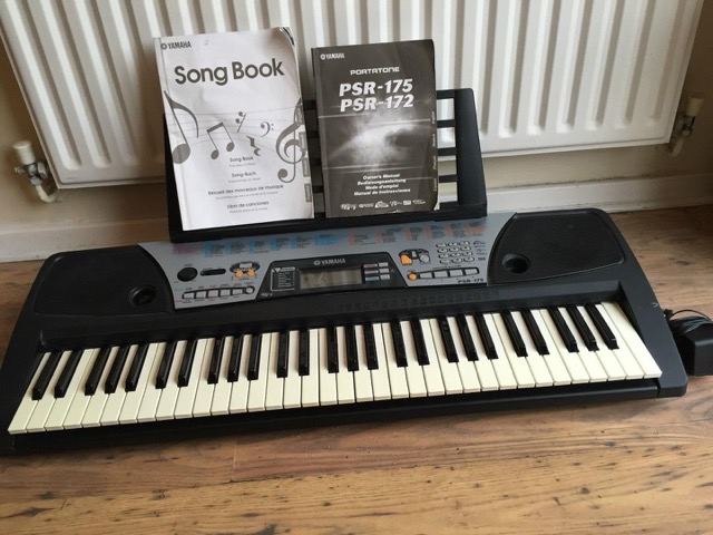 I spent a lot of time with a Yamaha PSR-175 keyboard and songbook just like this. (Photo from a Worthpoint auction listing)