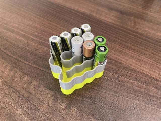 A one-piece holder for AA batteries.  Getting a consistent fit was near-impossible, as I learned that the dimensions of these cells weren't closely standardized. (2022)