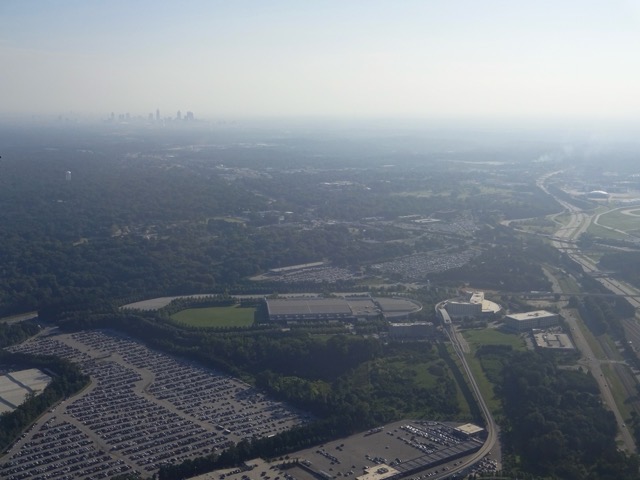 The distant skyline of Atlanta, GA, viewed through a plane window.