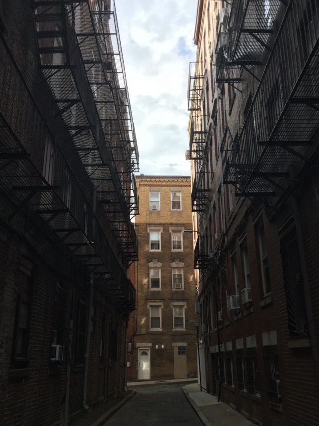 Fire escapes above a narrow alley in the North End of Boston, MA. (2017)